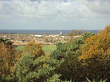 The view north-west from the top of Bidston Hill, across Leasowe and Moreton. The white tower at the shore is Leasowe Lighthouse, with Liverpool Bay of the Irish Sea beyond.