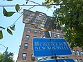 Plaque and sign for the College of New Rochelle along U.S. 1.