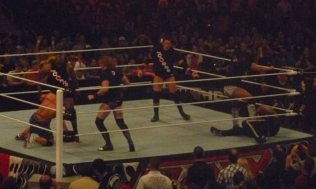The four members of The Corre attacking John Cena and The Rock