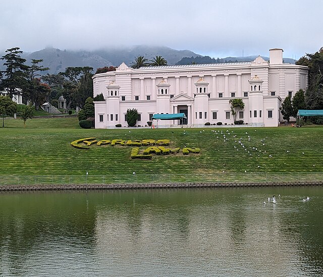 Lakeside Columbarium and pond with topiary sign; San Bruno Mountain can be seen in the background
