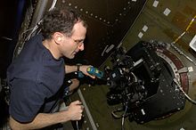 Astronaut Pettit operates the barn door tracker he constructed for ISS-based photography of the Earth's surface. Don pettit operates barn door tracker aboard ISS.jpg