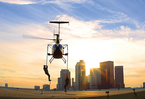 Federal Bureau of Investigation SWAT agents fast-roping from a helicopter during training near downtown Los Angeles