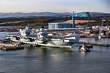 Prince of Wales is marshalled out of the basin at Rosyth for the first time, September 2019