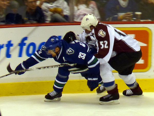 Foote defending against the Vancouver Canucks' Henrik Sedin in 2010