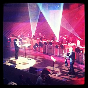 Luciano Chessa conducting the premiere of "It All Begins Now" by Lee Ranaldo, with Lee Ranaldo and the New World Symphony. A Performa Commission, New World Center, Miami Beach, December 2011. Luciano Chessa conducting the premiere of "It All Begins Now", Dec 2010.jpg