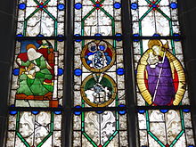 Stained glass windows depicting Elizabeth of Hungary (left), the coat of arms of Anna Schenk zu Schweinsberg (d. 1564), and Mary with the baby Jesus in the aureola (right) Marienstiftskirche Lich Fenster 10.JPG
