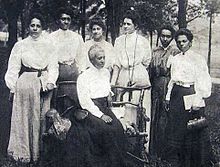 Women at the 1906 Niagara Movement Conference at Harpers Ferry: Mrs. Gertrude Wright Morgan (seated) and (left to right) Mrs. O.M. Waller, Mrs. F.H.M. Murray, Mrs. Mollie Lewis Kelan, Mrs. Ida D. Bailey, Miss Sadie Shorter, and Mrs. Charlotte Hershaw. Niagara-women.jpg