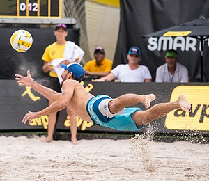 Unlike indoor volleyball, beach volleyball is played on soft sand which makes it safer for players to dive. Picture shows Nick Lucena of the United States diving to "dig" the ball. Nick Lucena at the AVP Austin Open 2017 (4).jpg