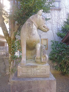 Detail view of the right fox guardian of the shrine Aratama Inari Jinja in Numazu with visible male genitalia