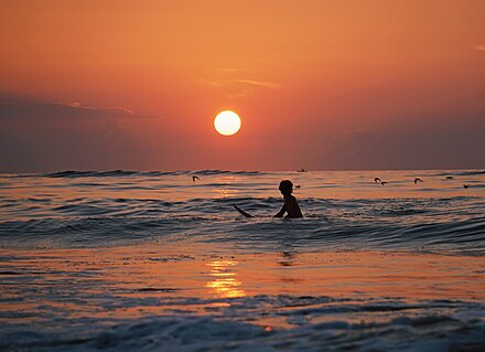 Surfing at sunset in Ocean City