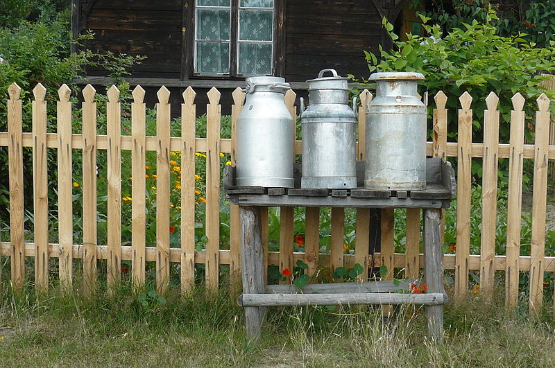 milk churn stand in Poland, Author: MOs810, CC0 Wikicommons