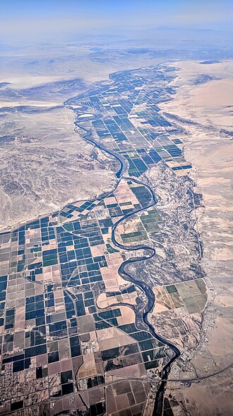 Aerial view looking north along the Palo Verde Valley and into the Parker Valley, where the Colorado River defines the border between California (left) and Arizona (right). A portion of the city of Blythe, California, and Ehrenberg, Arizona, and Interstate Highway 10 are visible at the bottom. Palo Verde Valley aerial.jpg