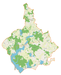 Mapa konturowa gminy Ryn, blisko centrum na lewo znajduje się owalna plamka nieco zaostrzona i wystająca na lewo w swoim dolnym rogu z opisem „Guber”