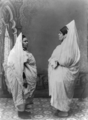 Two Jewish women standing, facing each other, in Tunisia.png