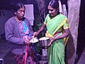 Two women are exchanging kosambari in a south Indian village during a festival