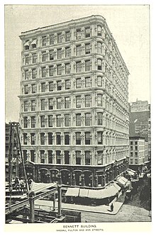 Black and white print of the Bennett Building's southern facade in 1893, shortly after its expansion. The building is shown with ten stories. The lowest two stories are darker in color than the upper eight stories.