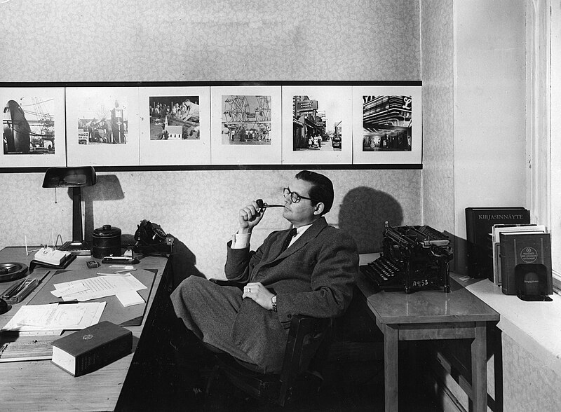 File:America Center Library historical photos of pipe smoking man at a desk.jpg