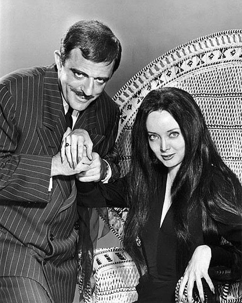 Astin alongside Carolyn Jones as Gomez and Morticia Addams in The Addams Family in 1964