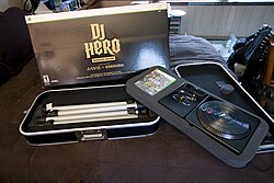 The "Renegade" edition of DJ Hero includes the turntable controller and a case that can be converted into a stand for the controller. DJ Hero spread out.jpg