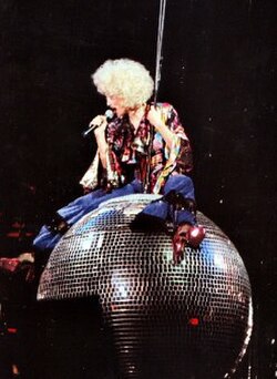 Madonna beginning the performance of "Express Yourself" on 1993's The Girlie Show World Tour, sitting on top of a disco ball.