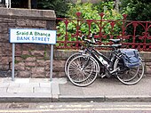 Bilingual signage in Fort William, Scotland with bicycles