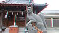 Fox statue in front of a local shrine