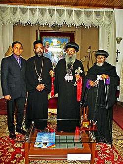 OCP Secretary George Alexander with Patriarch Abune Mathias of Ethiopia (with long red cuffs), Abune Thimotheos (Dean of Holy Trinity University College, with short purple cuffs), and Fr. Dr. Jossi Jacob (IMOC Delegate and Faculty at Holy Trinity College) George Alexander with Patriarch Abune Mathias, Abune Thimotheos and Fr. Dr. Jossi Jacob.jpg