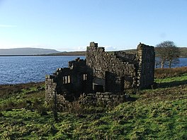 Image of a ruined building on the shoreline of a reservoir