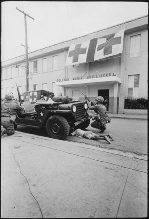 Humanitarian G.I.'s. Firefight where G.I. pushes little kid under jeep for protection, Santo Domingo, May 5., 1965 - NARA - 541806.tif