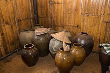 Jars for the making of the traditional rice wine of tapai in Sabah. KgKuaiKandazon Sabah Monsopiad-Cultural-Village-12.jpg