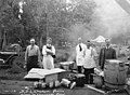 Men standing near table where beverages are prepared, Bloedel-Donovan Lumber Mills employees picnic, July 22, 1922 (INDOCC 1263).jpg