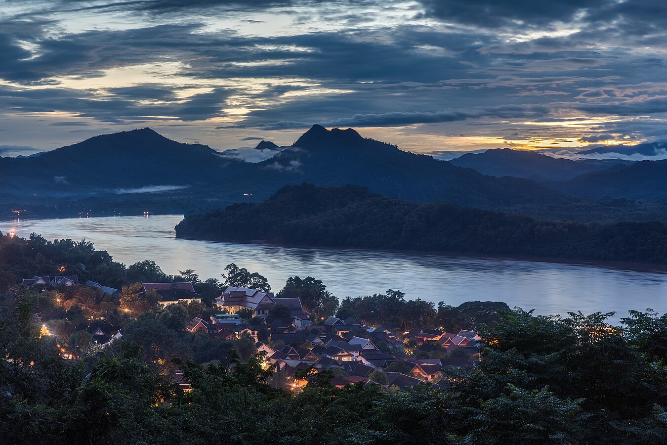 Mountains Mekong river and dwellings seen from Mount Phou Si at dusk in Luang Prabang Laos