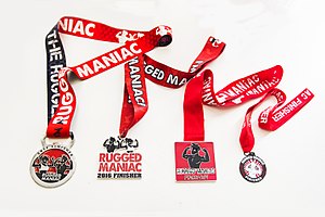 Progression of Rugged Maniac finisher medals. (from left to right: 2017 to 2014)
