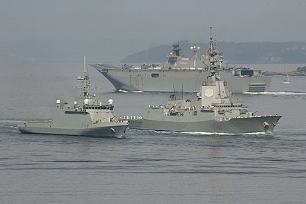 Naval parade of the Spanish Navy held in 2017. In the image, the BAM Tornado (P-44), the frigate Almirante Juan de Borbón (F-102) and in the background, the flagship amphibious assault ship Juan Carlos I (L-61).
