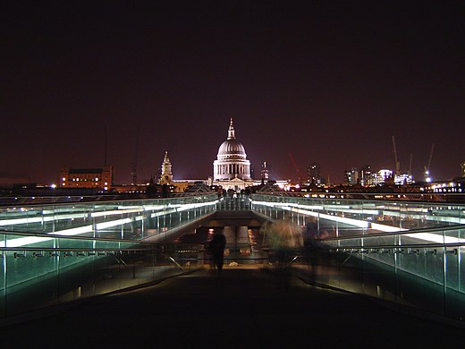 London Millennium Bridge at night, showing the much-photographed illusion of St. Paul's Cathedral being supported by one of the bridge supports