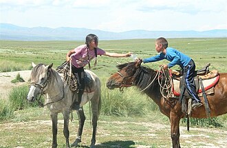 A girl and a boy riding their horses TIVALI URUGLAR.JPG