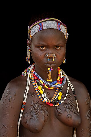 Young Laarim woman with extensive scarification, Kimotong, South Sudan.