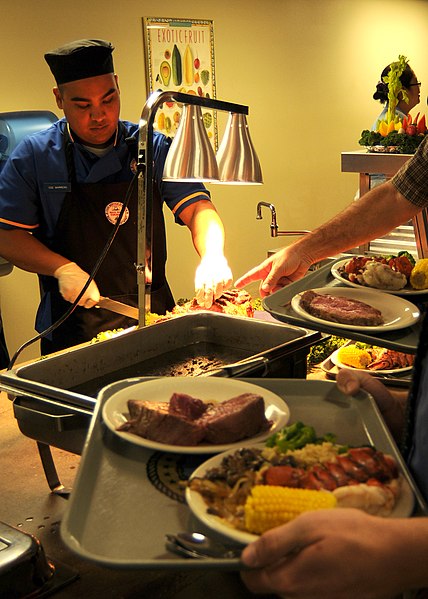 File:US Navy 101208-N-4322G-131 Culinary Specialist 2nd Class Victor Marrero serves prime rib and lobster during the grand opening of the Naval Amphibio.jpg