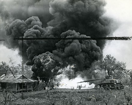Marines use a "Satan" to incinerate a Japanese pillbox on Siapan.