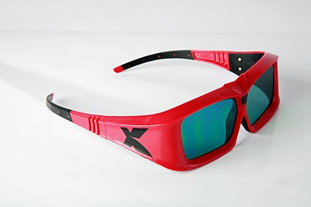 A pair of LC shutter glasses used to view XpanD 3D films. The thick frames conceal the electronics and batteries.