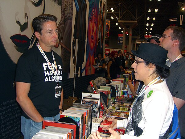 Top Cow President Matt Hawkins (left) speaking with fans (right) at the Image Comics booth at the 2012 New York Comic Con.