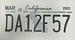 A temporary California license plate that has the state of California in the background in grey.