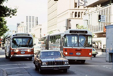 GM New Look (#314) and MAN SG 220 (#1629) in traffic with matching "clownface" livery