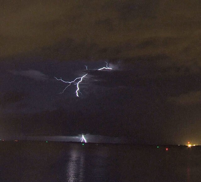 A bolt from the blue lightning strike which appears to initiate from the clear, but the turbulent sky above the anvil cloud and drive a bolt of plasma