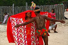 A dark-skinned Wayuu couple from Colombia. Many other Indigenous peoples of tropical or subtropical areas of the Americas have dark skin. Baile de cortejo Wayuu.jpg