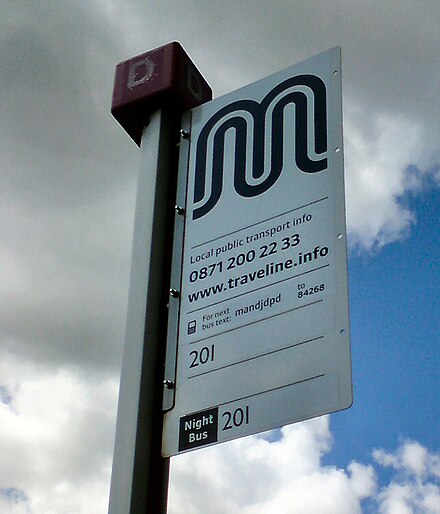 A bus stop in Denton bearing the logo of Transport for Greater Manchester (TfGM). TfGM is a functional executive body of the Greater Manchester Combined Authority and has responsibilities for public transport in Greater Manchester.