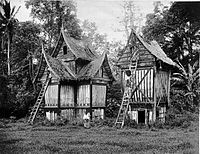 Two rangkiang in a photo c. 1895 of rice granaries in the Minangkabau architectural style in Batipuh in the Padang Plateau, Sumatra, Indonesia