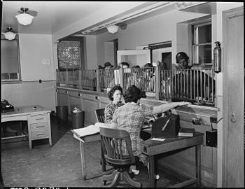 Miners borrowing from their paycheck, 1946 Credit department of the company. Miners are pictured drawing money in advance of payday. Inland Steel Company... - NARA - 541493.jpg