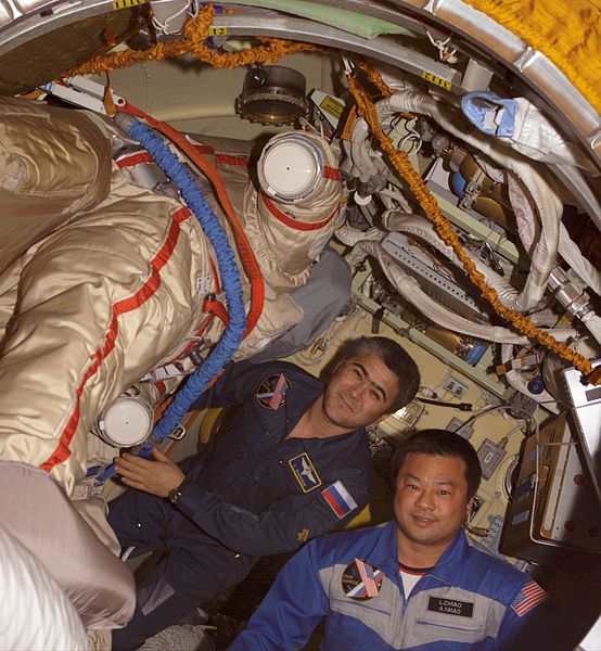 Salizhan Sharipov (left) and Leroy Chiao (right) work with their Russian Orlan spacesuits in the Pirs Docking Compartment of the International Space S