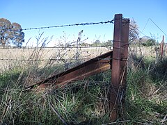 Railway line repurposed as farm fencing corner post